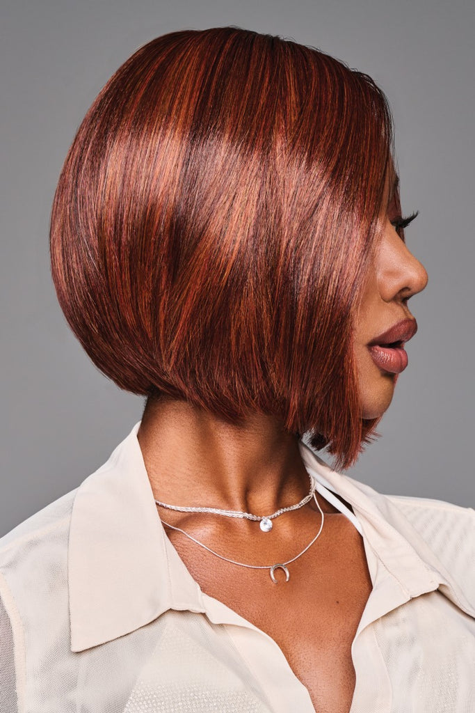 Other side of model wearing a copper color with dark brown roots.