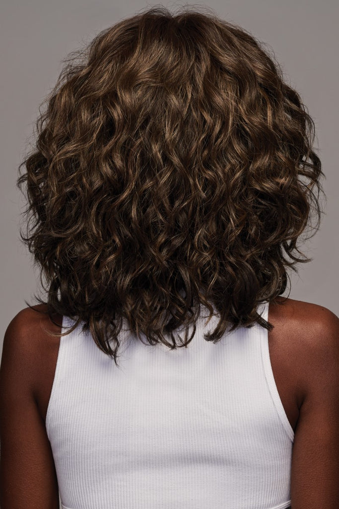Back side of women wearing a wig with luxurious natural texture and a bohemian elegance.