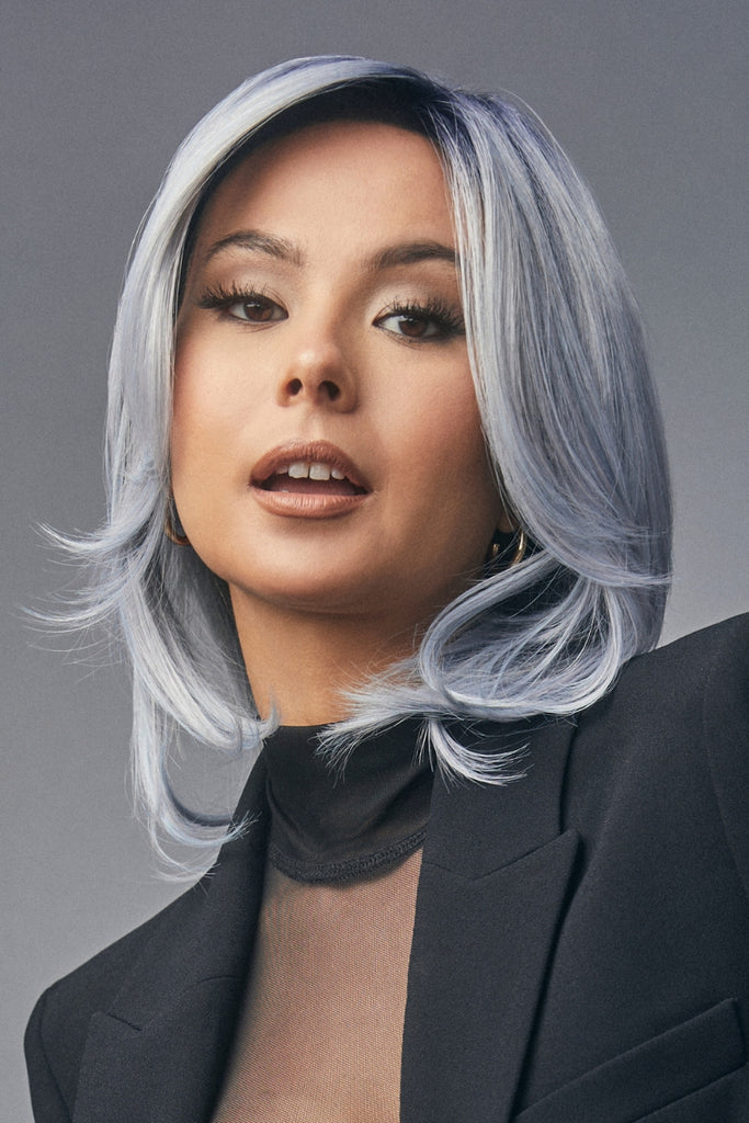 Model styling a long bob cut wig in the color Sapphire.