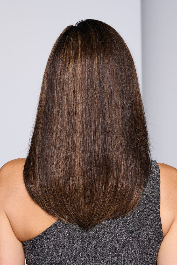 Woman wearing a long, layered style in a dimensional brunette color.