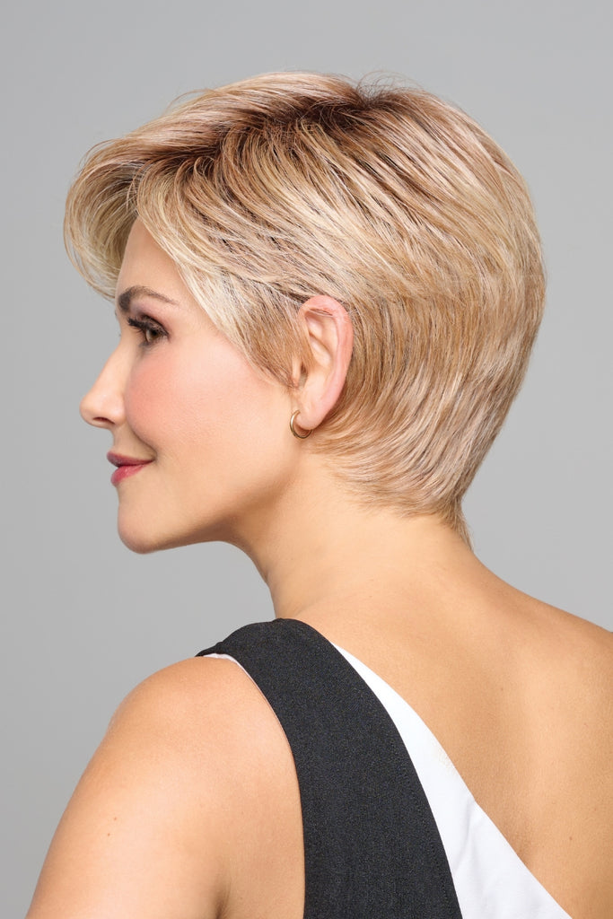 Side profile of woman wearing a blonde layered pixie wig by Raquel Welch.
