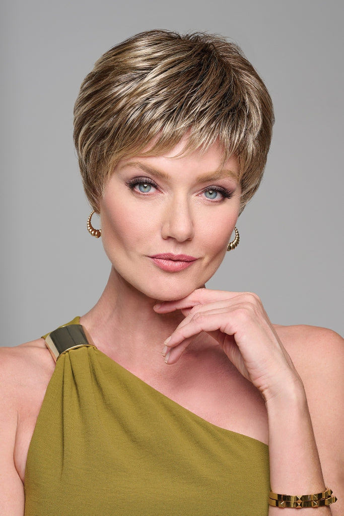Woman wearing a short pixie cut with razor like tapering.