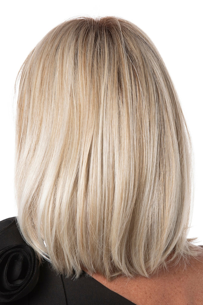 Back of woman wearing Flawless Bob in a dimensional blonde color with dark roots.