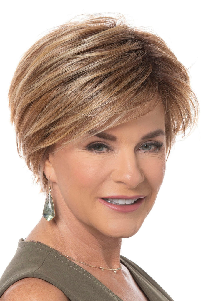 Close up od model styling a layered bob cut wig with a tapered razor cut nape.