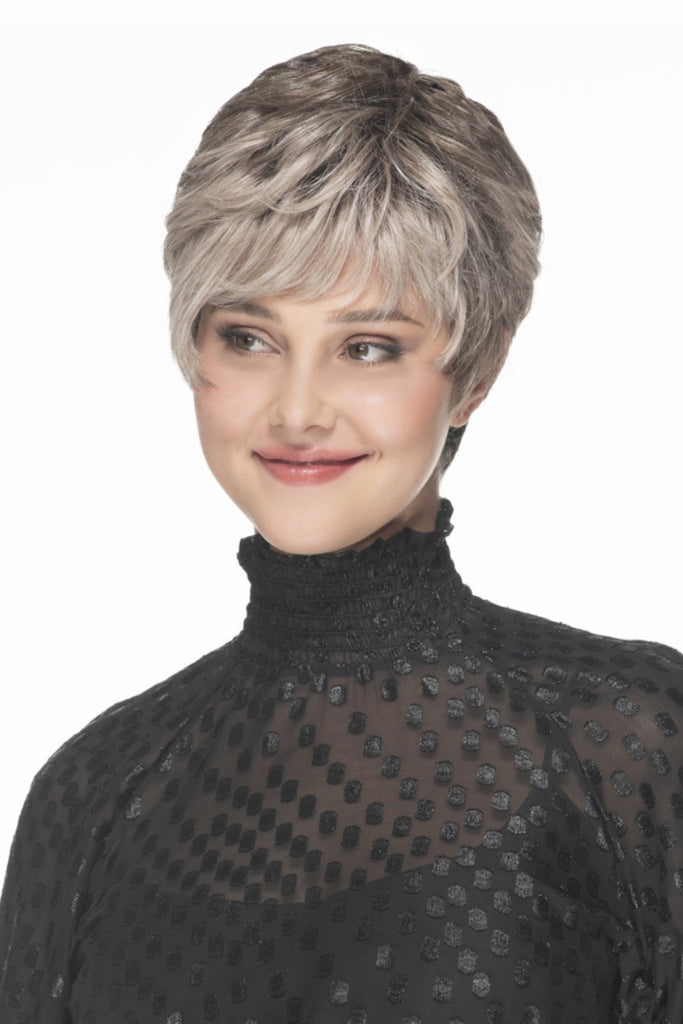 Model wearing a lightweight, layered short pixie cut wig.