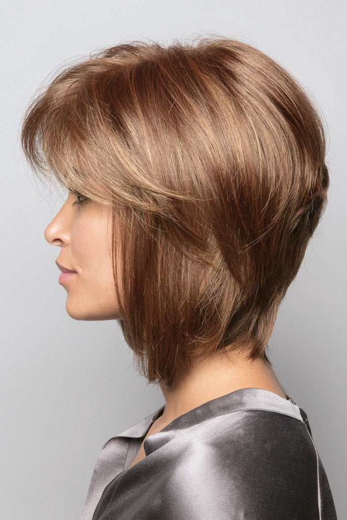 Side view of model wearing Cocoonut Spice, medium reddish brown base with light reddish brown and light blonde highlights.