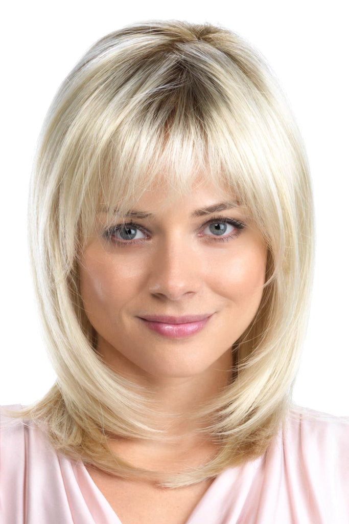 Confident woman looking forward as she wears Tony of Beverly's wig Hunter, a layered lob with face framing bangs.